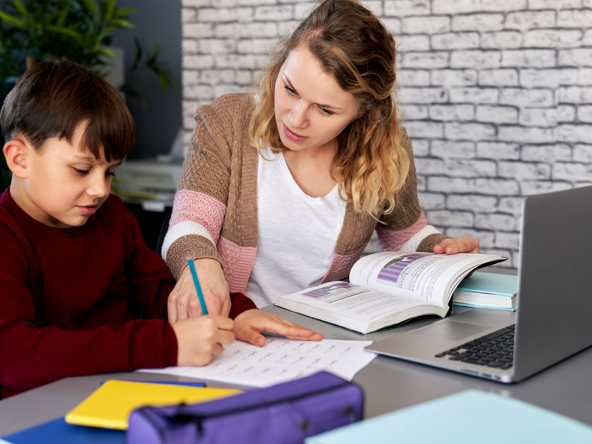 Woman tutoring a child in Balwyn's school facilities